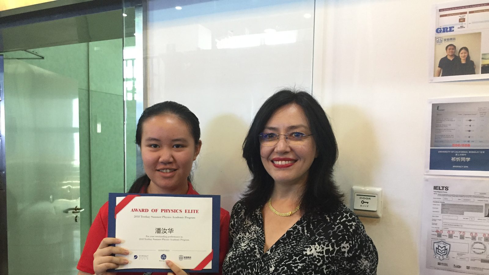Zhanna Williams with a student holding an Award of Physics Elite certificate
