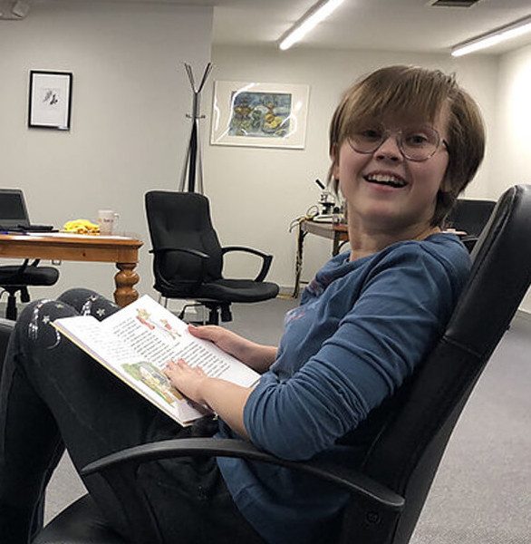 A young student reading during a lesson